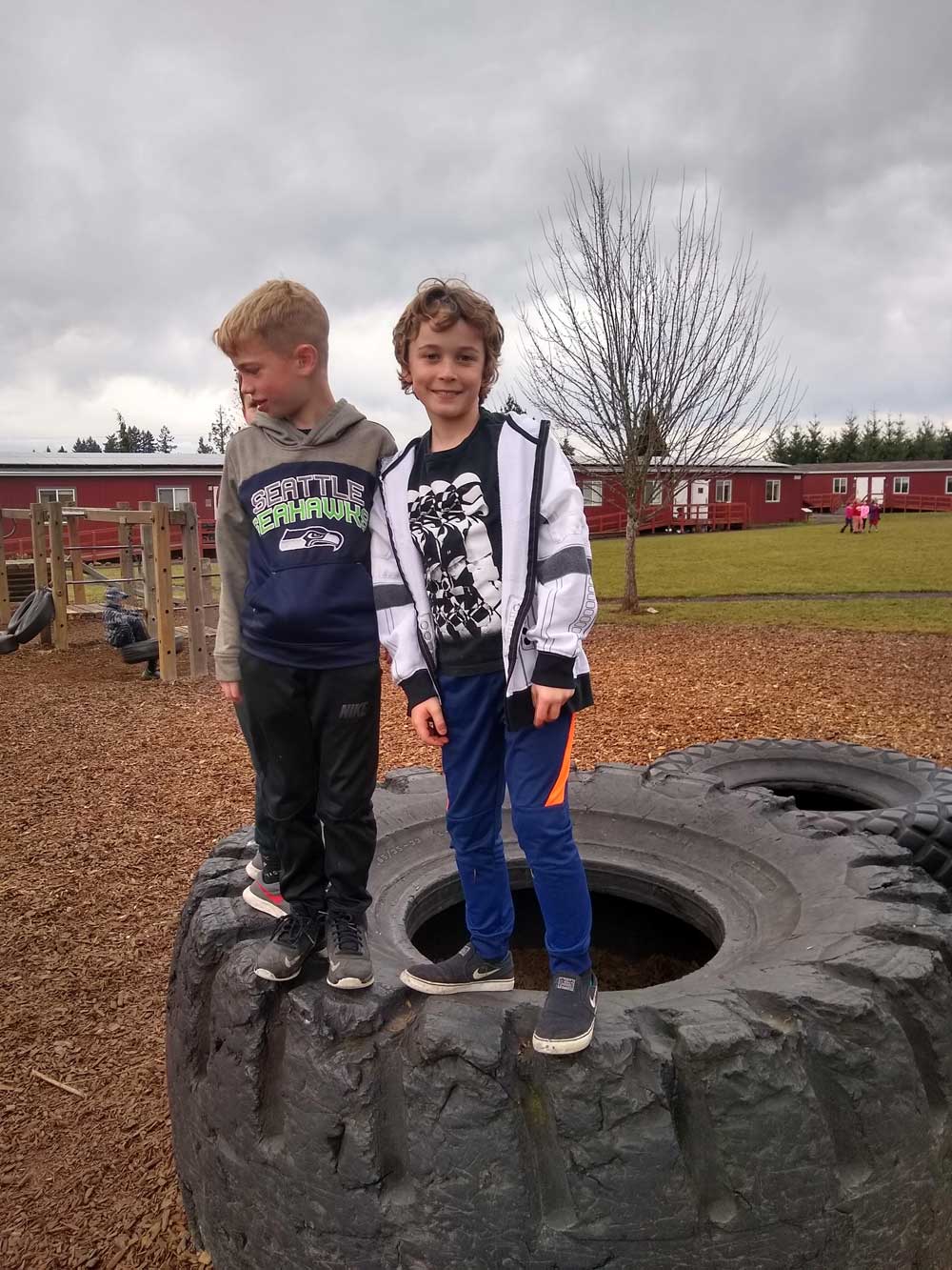 Springwater kids on the playground balancing on a giant tire