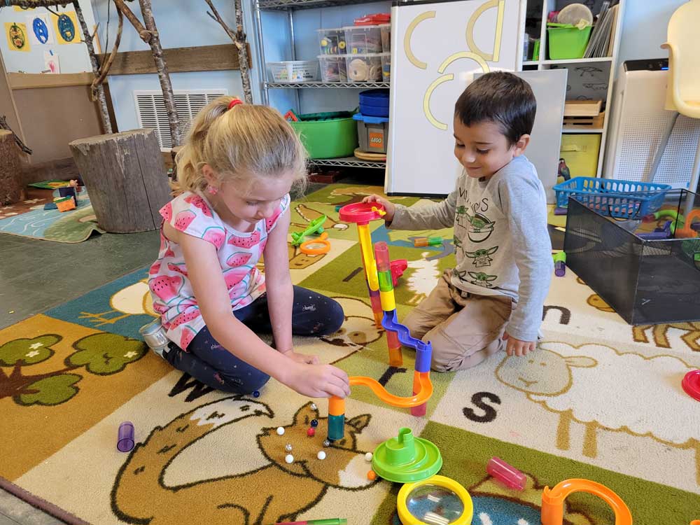 Springwater preschool kids playing with a marble run